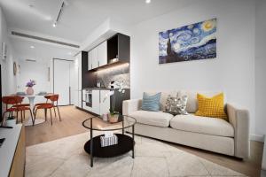 a living room with a couch and a table at Brand New Luxury Stay with Garden View Same Tower as Ritz Carlton in Melbourne
