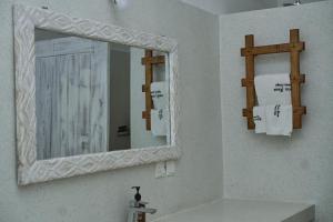 a bathroom with a mirror and a sink at White Villa Paparemo Village in Watamu