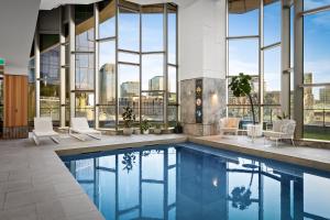 a pool in a building with a view of the city at Brand New Luxury Stay with Garden View Same Tower as Ritz Carlton in Melbourne