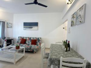 a living room with a table and a couch at Villa By The Beach Goa in Benaulim