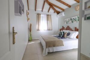 a bedroom with a bed and a window at L Échappée Belle Havre de paix au cœur du verger in Le Moule