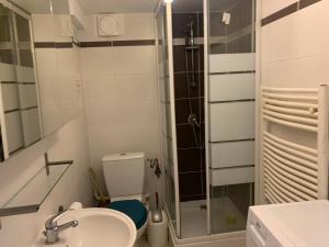 a bathroom with a toilet and a sink and a shower at La Grande Maison Paris Sud in Vitry-sur-Seine