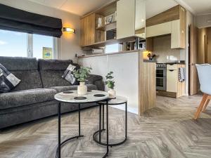 a living room with a couch and a table at Coastal Bay View in Ayr