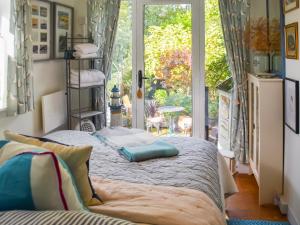 WangfordにあるAlec Hill's Bakehouseのベッドルーム1室(窓の前にベッド2台付)