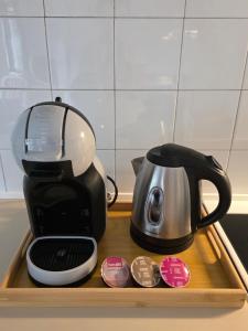 a coffee maker sitting on top of a wooden tray at Apartment Break in Rob