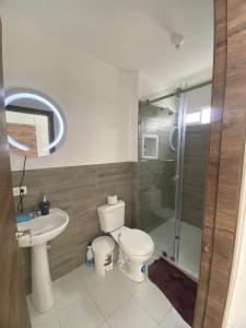 a bathroom with a toilet and a shower and a sink at Welcome to your perfect Manta Coast getaway in Manta +12 photos