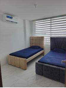 a bedroom with two beds and a window at Welcome to your perfect Manta Coast getaway in Manta