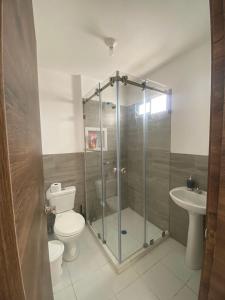 a bathroom with a shower and a toilet and a sink at Welcome to your perfect Manta Coast getaway in Manta