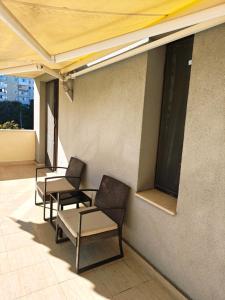 a group of chairs and tables on a balcony at Trend Apart in Burgas City