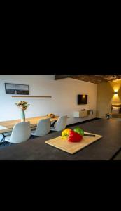 a dining room with a table and chairs and a table and a tableablish at Le Marzelheide 1 in Lontzen