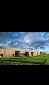 a group of horses walking in front of a building at Le Marzelheide 1 in Lontzen