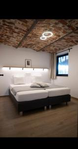 a bedroom with a large bed with a ceiling at Le Marzelheide 1 in Lontzen +21 photos