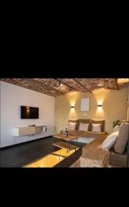 a living room with a couch and a tv at Le Marzelheide 1 in Lontzen