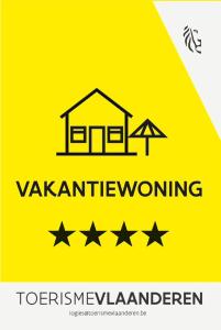 a yellow sign with a house on it with stars at Zilt 0202 in Westende