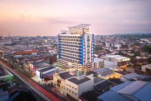 an overhead view of a city with a tall building at Wahid Prime Hotel Salatiga in Salatiga