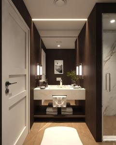 a bathroom with a white sink and a mirror at Fredvang Lodge, Lofoten in Hovdan