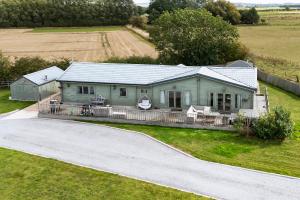 an aerial view of a house with a driveway at Beautiful 3-Bed Luxury Private Lodge in York in York