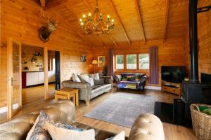 a living room with a couch and a tv at Beautiful 3-Bed Luxury Private Lodge in York in York