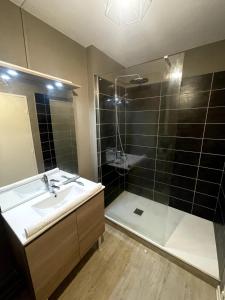 a bathroom with a sink and a shower at Leo Lagrange in Champforgeuil +6 photos