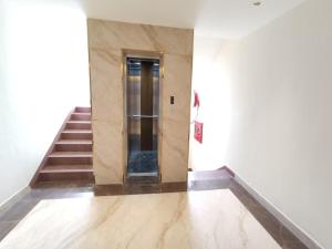 a hallway with a door and stairs in a building at Sivashree Residency in Tiruvannāmalai