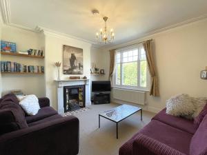a living room with two couches and a fireplace at Sterling House in Robin Hood's Bay