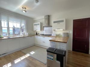 a kitchen with white cabinets and a counter top at Sterling House in Robin Hood's Bay