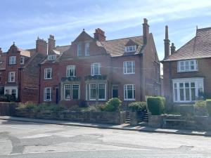 a large red brick house with white windows at Sterling House in Robin Hood's Bay