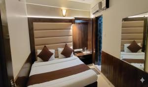 a bedroom with a bed and a desk in a room at Raghunath Jammu in Jammu +29 photos