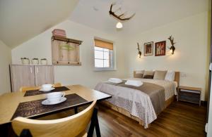 Postel nebo postele na pokoji v ubytování Šv Hubertas