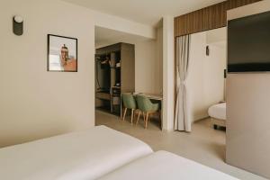 a hotel room with a bed and a desk at Regional Hotel by NEU Collective in Il-Gżira +30 photos