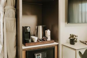 a shelf with a coffee maker on top of a fireplace at Regional Hotel by NEU Collective in Il-Gżira +1 photo