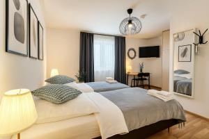 a bedroom with a large bed and a desk at Airport Messe Hotel in Düsseldorf
