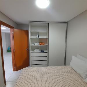 a bedroom with a bed and a closet at Apartamento em João Pessoa in João Pessoa +11 photos