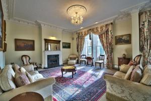 a living room with couches and a fireplace at Milton House Group Retreats in Bedford