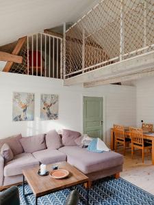a living room with a couch and a table at Magical Barn Near The Sea in Ytterby