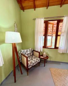 a living room with a chair and a lamp at HAVEN-Your Private Mountain Sanctuary in Talatuoya