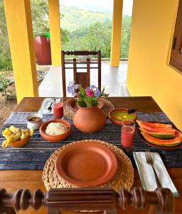 a table with plates and bowls of food on it at HAVEN-Your Private Mountain Sanctuary in Talatuoya