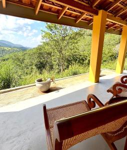 a bench on a porch with a view of the mountains at HAVEN-Your Private Mountain Sanctuary in Talatuoya +19 photos