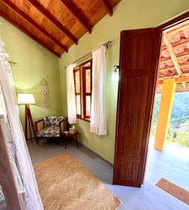 an open door to a room with a chair and a window at HAVEN-Your Private Mountain Sanctuary in Talatuoya