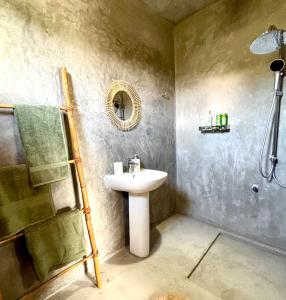a bathroom with a sink and a shower at HAVEN-Your Private Mountain Sanctuary in Talatuoya