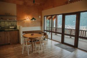 une cuisine et une salle à manger avec une table et des chaises dans l'établissement Ліснів, à Tatariv 23 autres photos