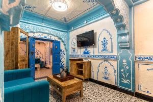 a room with blue and white walls and a blue couch at Storica Stays in Jodhpur