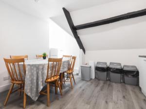a dining room with a table and four trash cans at Room 1 At The Cwtch in Chepstow