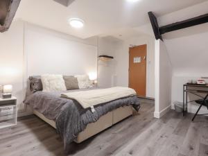 a bedroom with a large bed and a desk at Room 1 At The Cwtch in Chepstow
