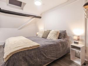 a bedroom with a bed in a white room at Room 1 At The Cwtch in Chepstow