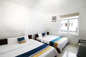 Postel nebo postele na pokoji v ubytování Bảo Quân Hotel