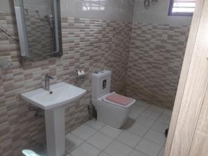 a bathroom with a white toilet and a sink at Bly & schol home apartment in Aso