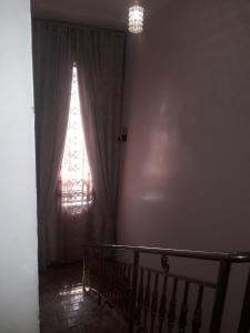 a room with a window and a staircase with a curtain at Bly & schol home apartment in Aso