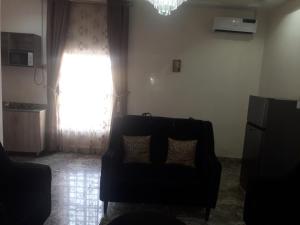 a living room with a couch and a window at Bly & schol home apartment in Aso