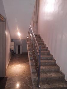 a stairway in an old building with a metal railing at Bly & schol home apartment in Aso